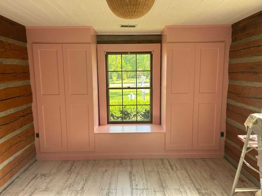 Finished pink built-in cabinet and bench project around a window