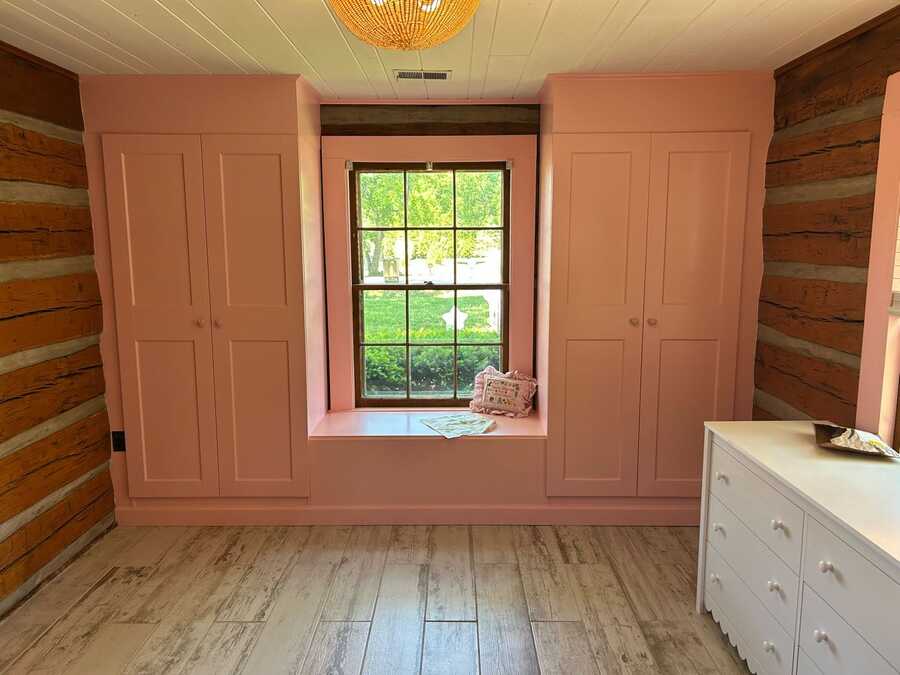 Finished room angle with painted built-ins and bench